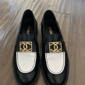 CHANEL Black and White Flats with Gold Emblem